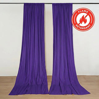 Purple flame-retardant curtain panels hanging on a rod in a studio setting