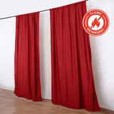 Red flame retardant curtains on hanging rod with fire safety badge