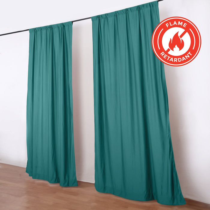 Teal flame retardant curtains on a black rod in a room