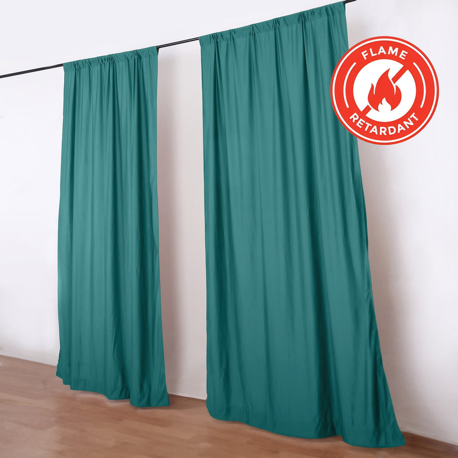 Teal flame retardant curtains on a black rod in a room