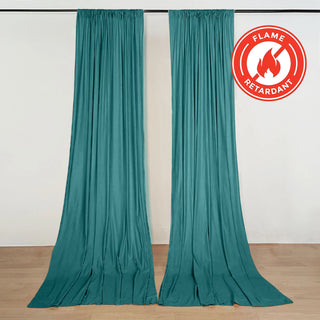 Teal flame-retardant curtains hanging on a rail in a studio room