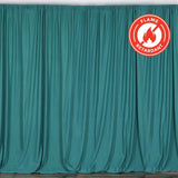 Flame-retardant teal curtain draped elegantly in a studio setting.