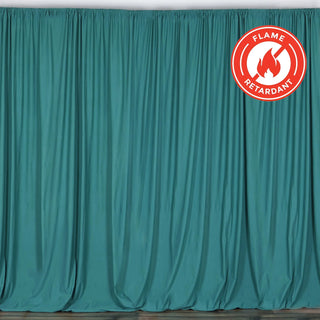 Flame-retardant teal curtain draped elegantly in a studio setting.