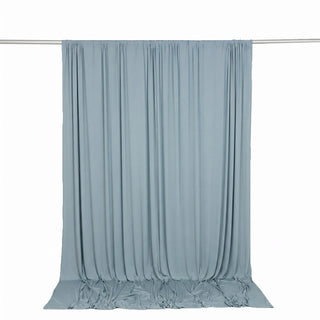 Light blue sheer curtain backdrop on hanging rod