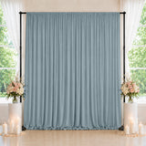 Elegant blue wedding backdrop with floral arrangements and candles by windows