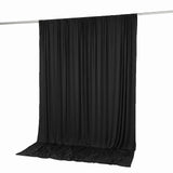 Black draped backdrop curtain on support rod, studio photography background