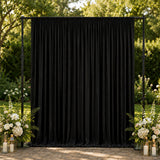 Black outdoor drape backdrop with floral wedding decor and lanterns