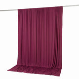 Magenta draped stage curtain on hanging rod isolated on white background