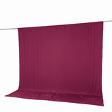 Magenta fabric backdrop with hanging rod on white background