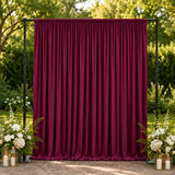 Burgundy velvet backdrop curtain with floral wedding decor outdoors