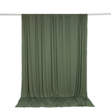 Olive green draped fabric backdrop with rod hanging on white background