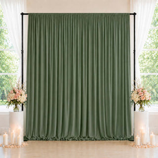Olive green wedding backdrop curtain with floral arrangements and candles
