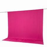 Pink sheer fabric backdrop hanging on a rod against a white background