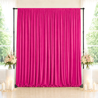 Pink satin backdrop curtain with floral decor and candles for event photography
