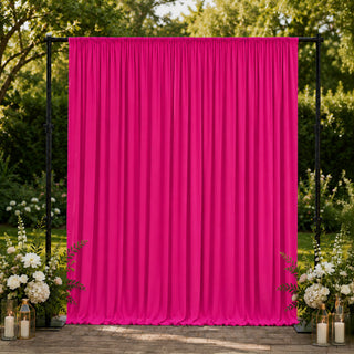 Bright pink outdoor event curtain backdrop with floral wedding décor