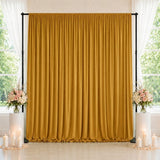Gold wedding backdrop curtain with floral arrangements and candles