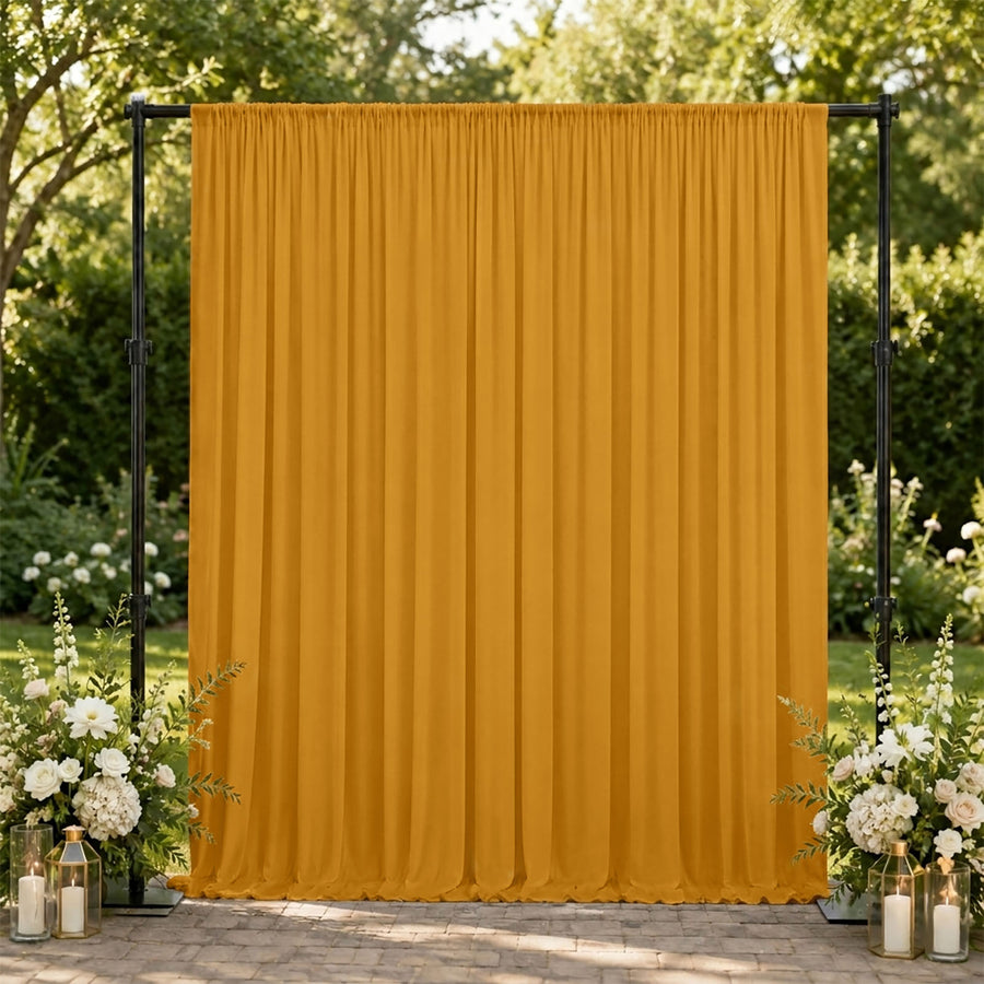 Mustard yellow wedding backdrop with floral arrangements outdoors