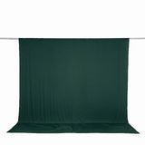 Dark green studio backdrop curtain on crossbar, white background