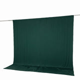 Dark green photography backdrop cloth on hanging rod