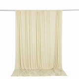 Cream sheer curtain panel hanging on a rod, elegant draped fabric backdrop