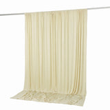 Cream draped fabric curtain backdrop on rod, studio background for photography