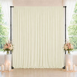 Elegant wedding backdrop with cream drape, floral arrangements, and candles