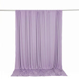 Light lavender sheer curtain draped on a rod with floor pooling fabric