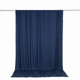 Navy blue sheer curtain backdrop on hanging rod against white background