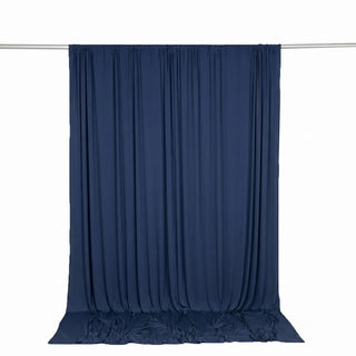 Navy blue sheer curtain backdrop on hanging rod against white background