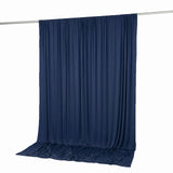 Navy blue draped fabric backdrop on curtain rod, studio background