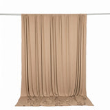 Beige draped fabric backdrop curtain on hanging rod, studio photography background