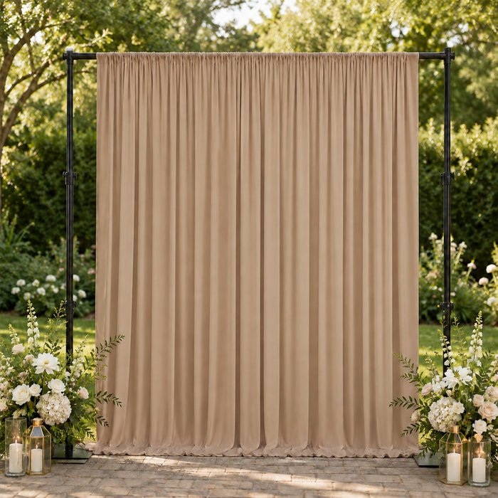 Beige wedding backdrop curtain with floral arrangements and lanterns outdoors