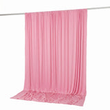 Pink draped fabric curtain backdrop hanging on a rod, studio background