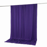 Purple draped fabric backdrop hanging on a curtain rod, studio background