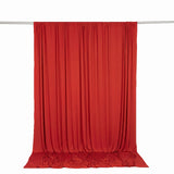 Red sheer curtain draped on a metal rod against a white background