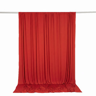 Red sheer curtain draped on a metal rod against a white background