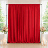 Red wedding backdrop curtain with floral arrangements and candles