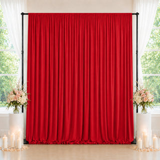 Red wedding backdrop curtain with floral arrangements and candles