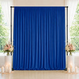 Blue wedding backdrop with floral arrangements and candles by windows