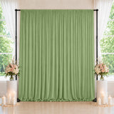 Green wedding backdrop curtain with floral arrangements and candles, indoor event decor