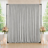 Elegant silver backdrop curtain with floral arrangements and candles for events