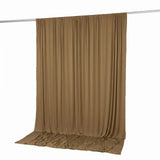 Brown draped curtain hanging on a rod against a white background