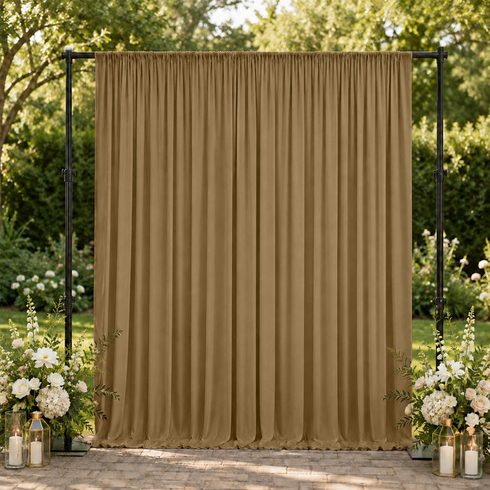 Gold wedding backdrop curtain with floral arrangements and lanterns outdoors
