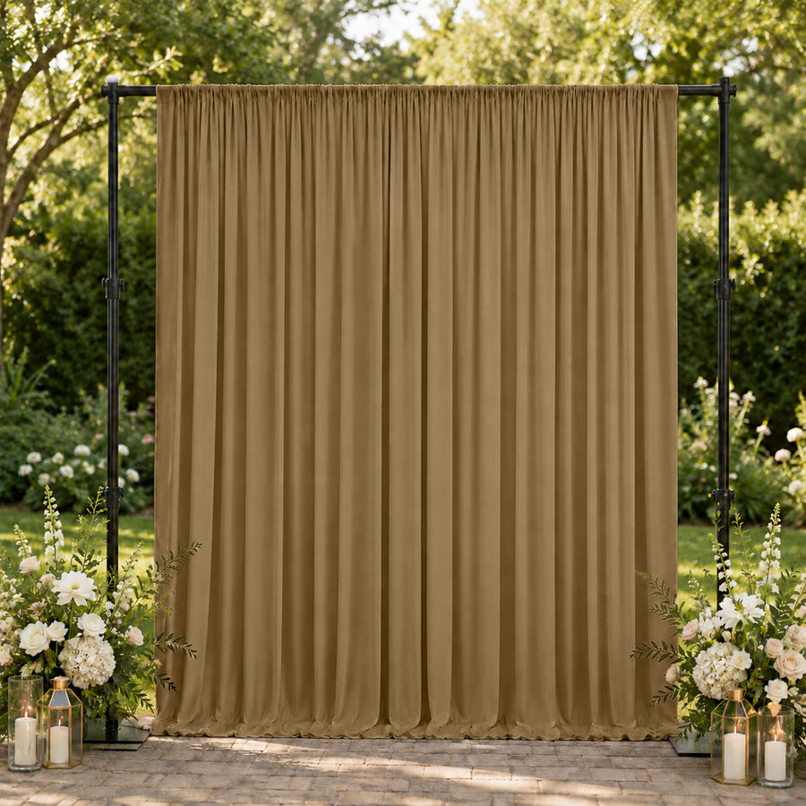 Gold wedding backdrop curtain with floral arrangements and lanterns outdoors