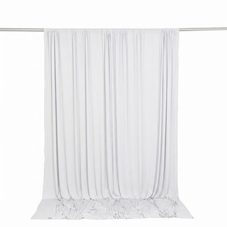 White sheer curtain panel hanging on a rod with soft flowing drapes