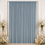 Elegant blue curtain backdrop with white floral arrangements and candles