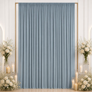 Elegant blue curtain backdrop with white floral arrangements and candles