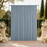 Outdoor wedding backdrop with blue curtain and floral candle arrangements