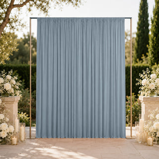 Outdoor wedding backdrop with blue curtain and floral candle arrangements
