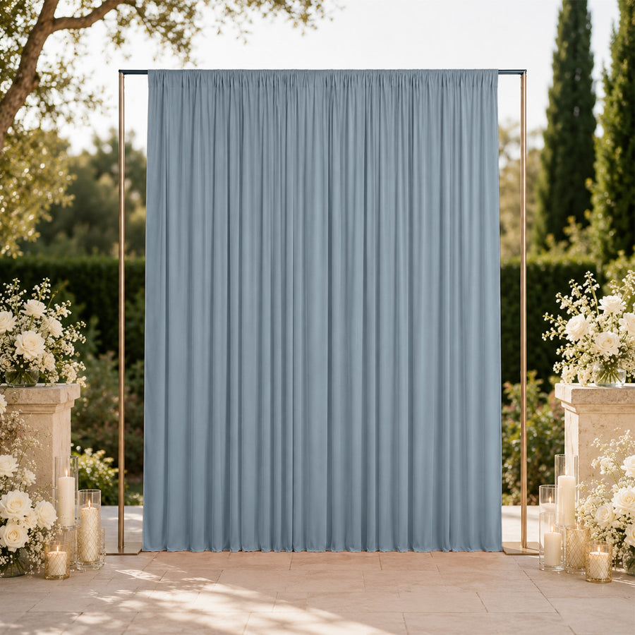 Outdoor wedding backdrop with blue curtain and floral candle arrangements